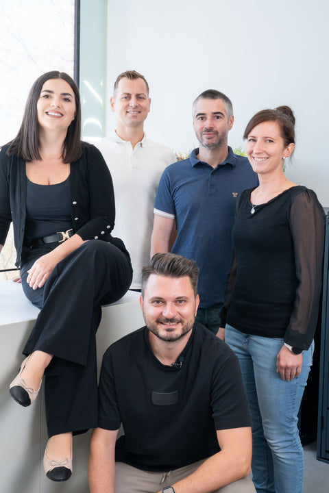 A group of five smiling people in the Bio Stefan office.