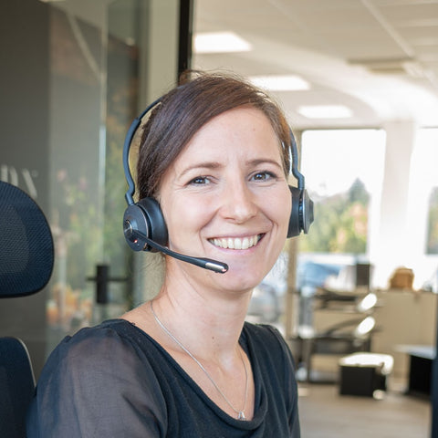 Smiling woman with headset in an office of Bio Stefan.