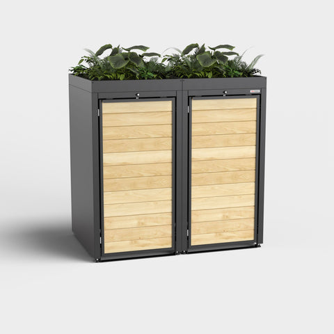 Cutie pentru două tomberoane de gunoi de la BIO Stefan cu plante pe acoperiș.