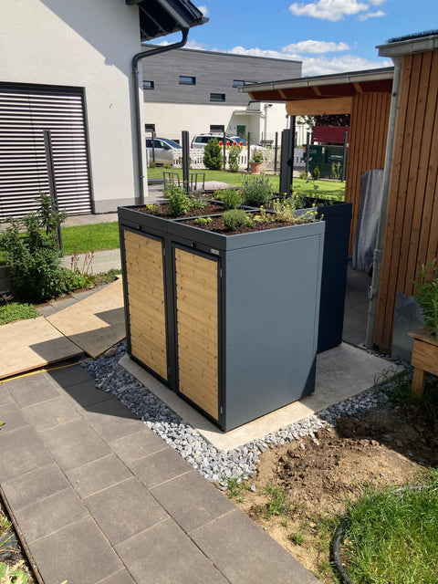 Double trash bin box from BIO Stefan with planted roof in the garden.