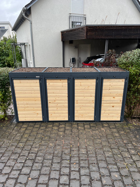 Trash bin boxes made of wood and metal in front of a residential house.