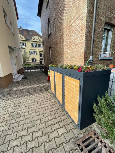 Bio Stefan wheelie bin box with plant roof placed in the courtyard.