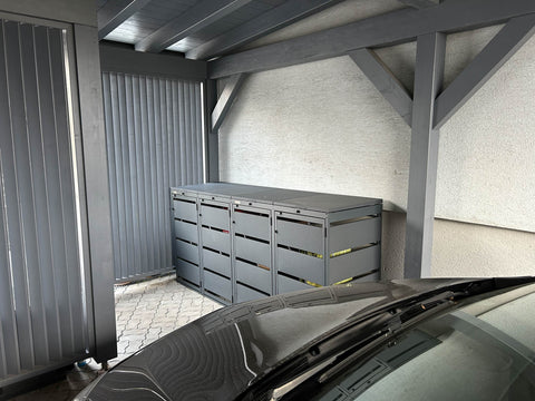 BIO Stefan Mülltonnenbox Dagobert 4er 120l in Anthrazit unter Carport neben geparktem Auto