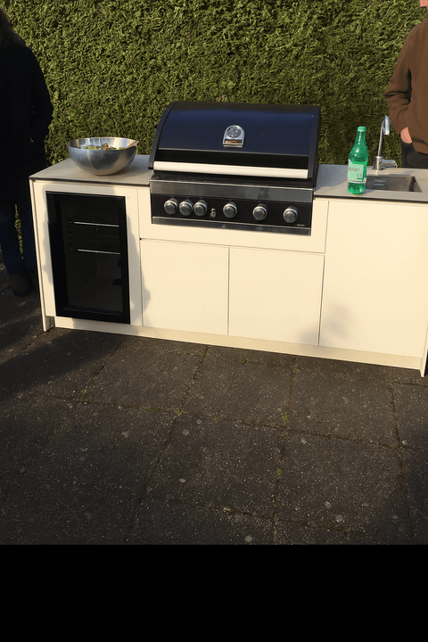 Outdoor kitchen with grill and sink on the terrace.