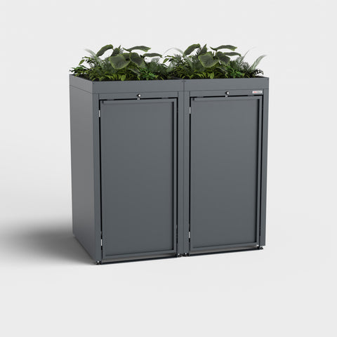 Două cutii gri Stahlfred pentru coșuri de gunoi cu plante pe acoperiș.